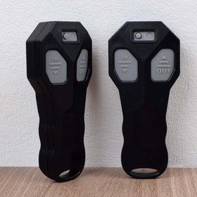 Royitay handheld remote next to hand showing compact size and ergonomic benefit