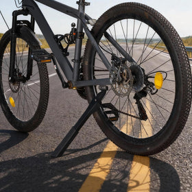 RUTU kickstand supporting a parked bike on gravel showcasing steadiness