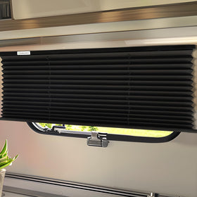 RVINGPRO front view of packaged 50x32 black RV blind, ready to install for shade