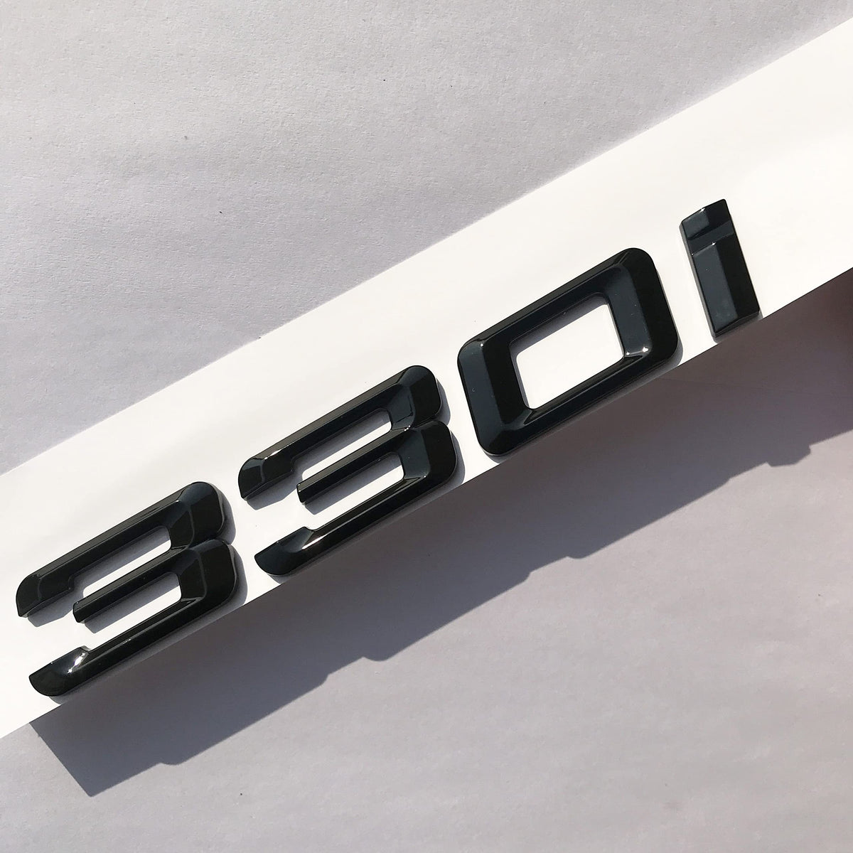 Sadkunf 330i emblem close-up of 3M adhesive backing for secure, long-lasting bond