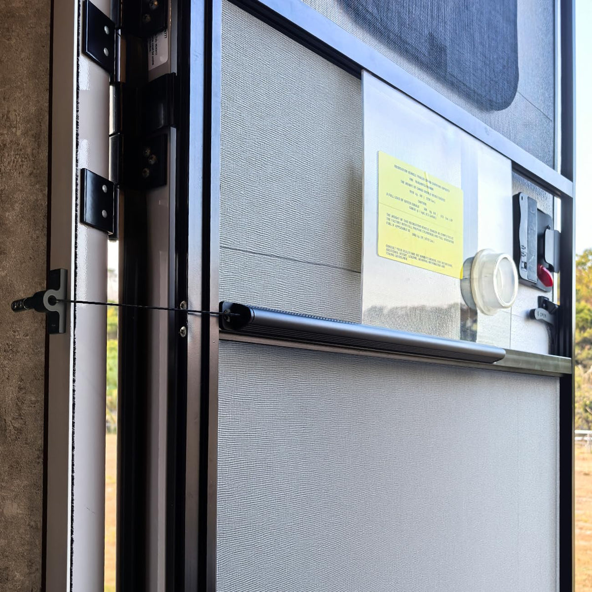 Safoner front view mounted on RV screen door showing neat fit and quick closure