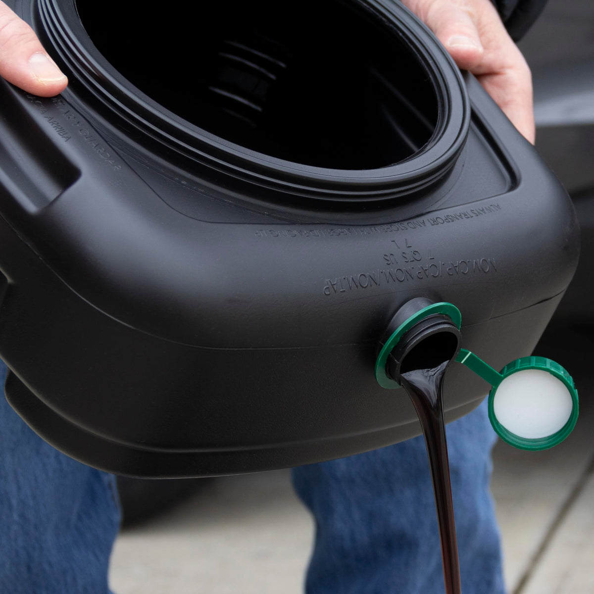 Scepter pan next to tools to show compact size and easy garage storage