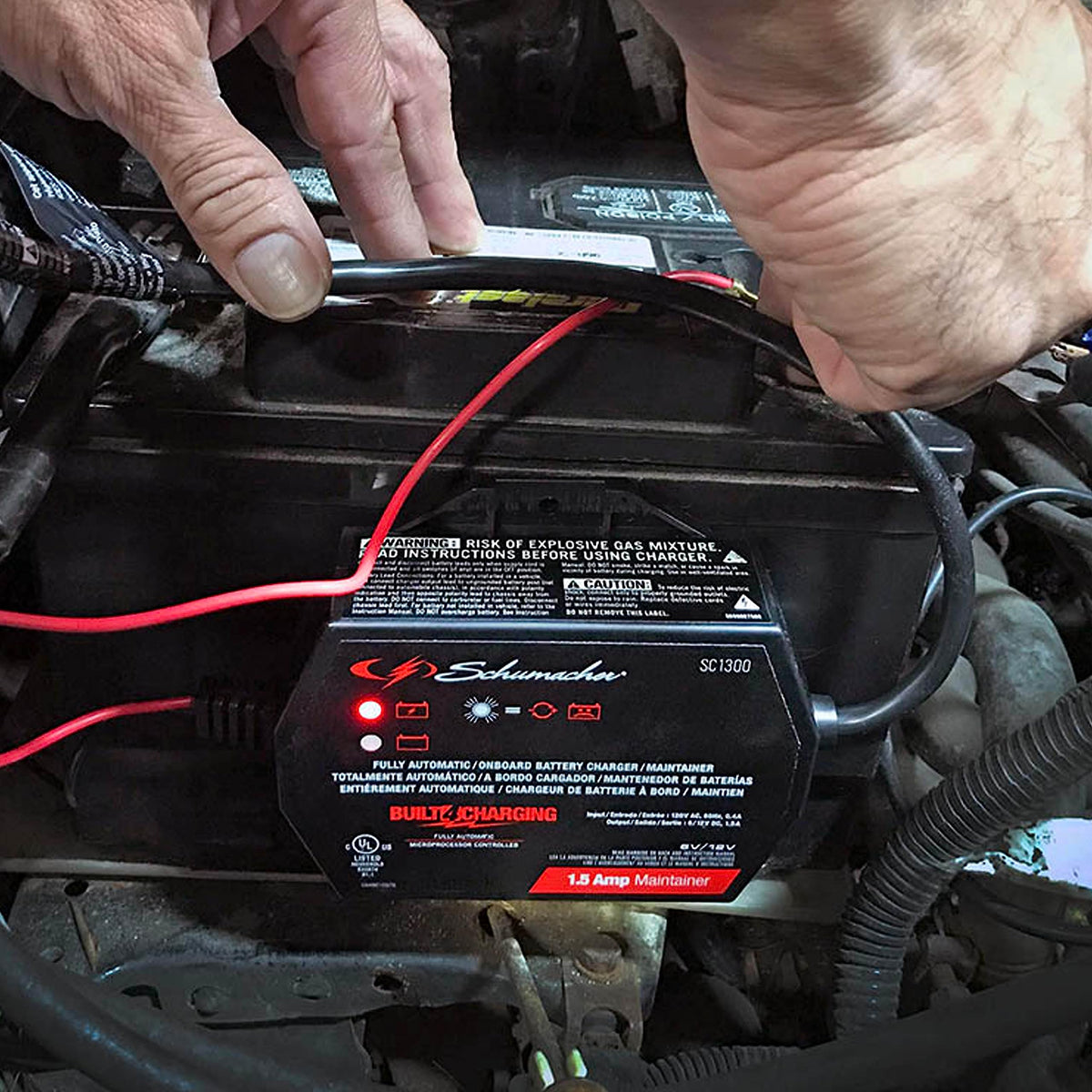 Schumacher SC1300 connected to motorcycle battery providing reliable maintenance