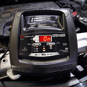 Schumacher SC1308 compact unit next to a tape measure showing portable size and workshop fit