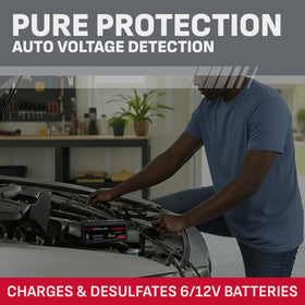 Schumacher unit connected to car battery in garage showing reliable maintenance and peace of mind