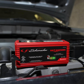 Schumacher SP1296 connected to a car battery illustrating charging in progress for reliable starts