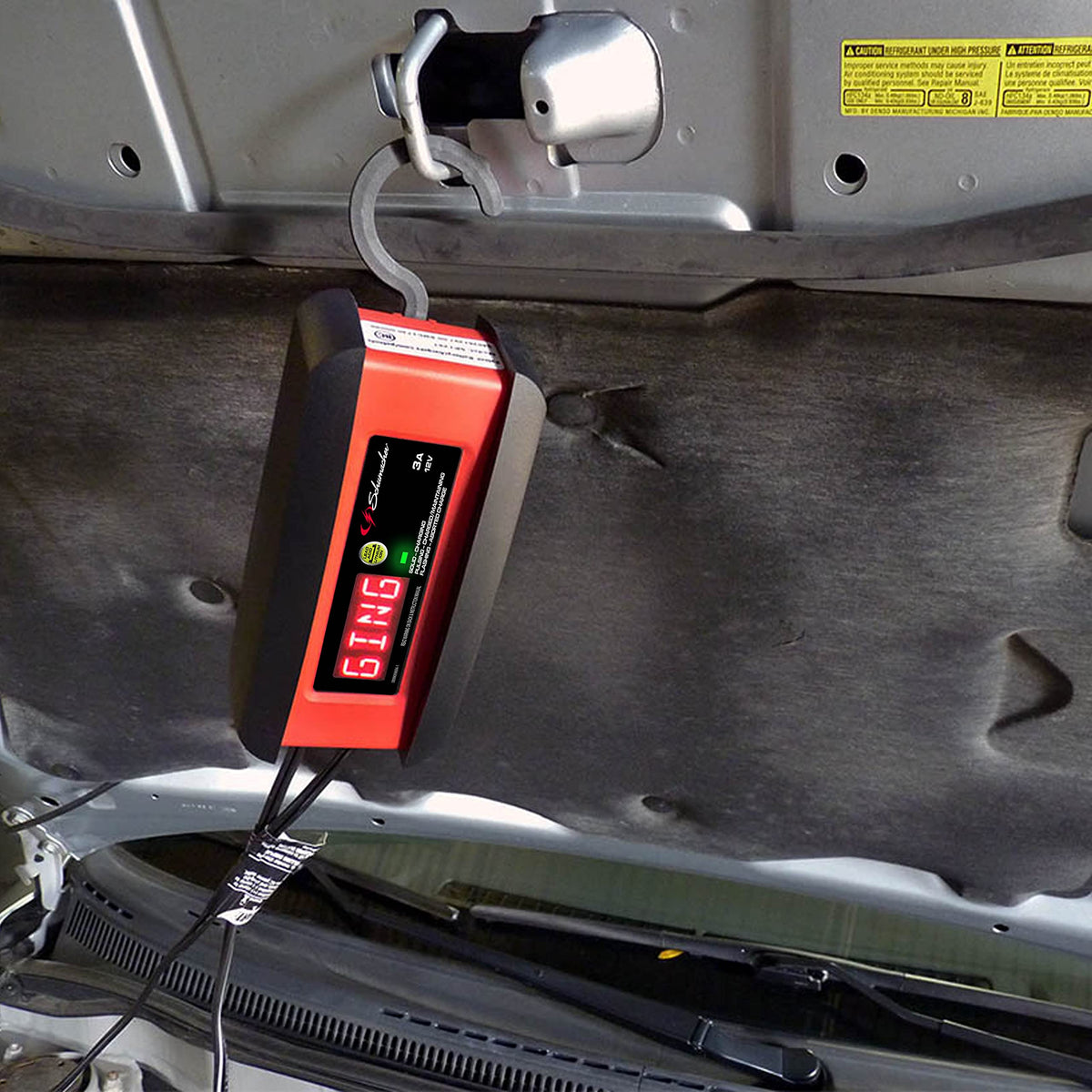 Schumacher Electric folded hook mounted to hang charger, safe out‑of‑work‑area placement benefit