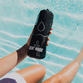 Seat Hoodie next to water bottle showing size and lightweight portability
