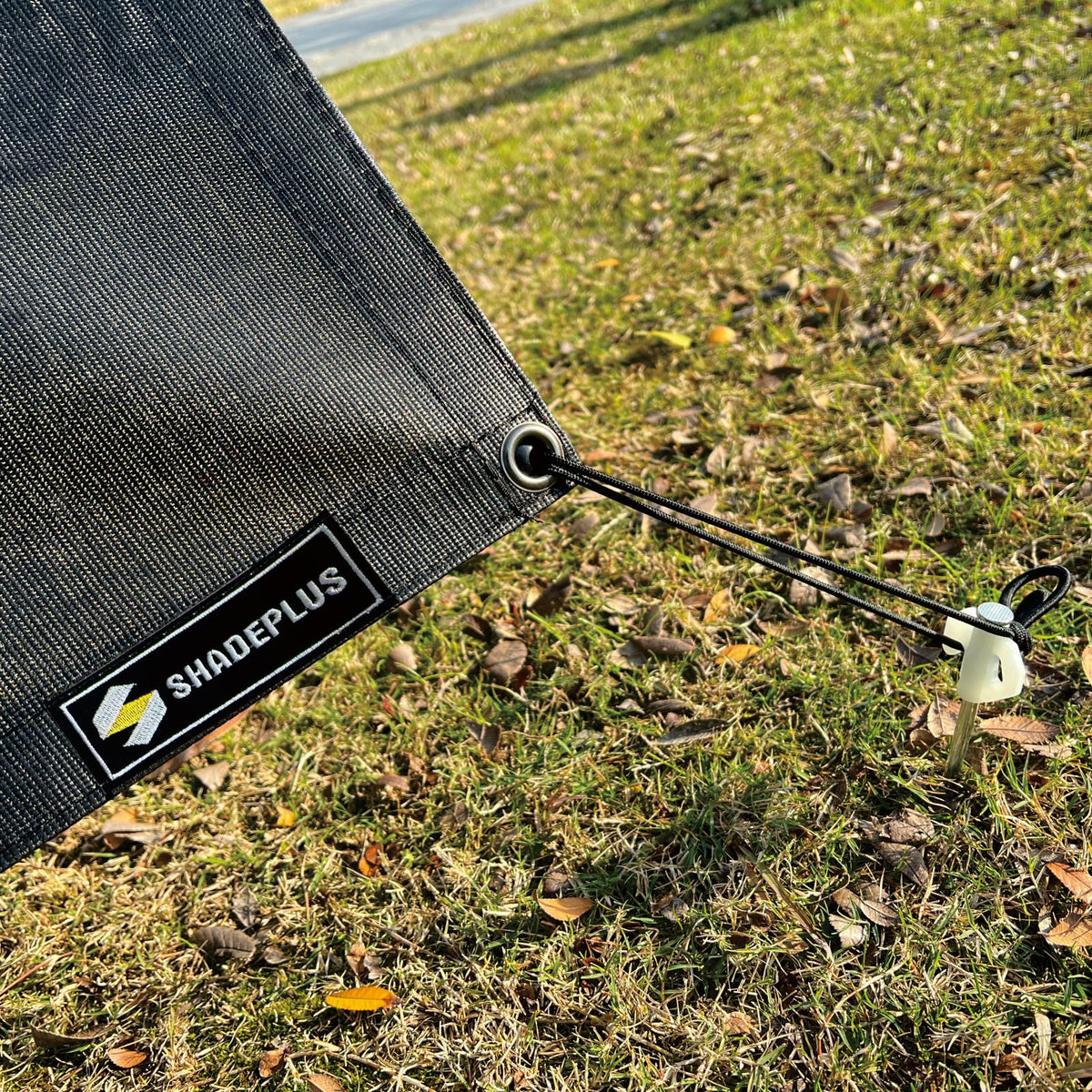SHADEPLUS anchored with stakes illustrating stable tension and reduced wind flap