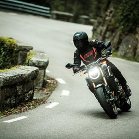 Shoei RF-1400 next to helmet bag showing compact, travel-friendly sizing