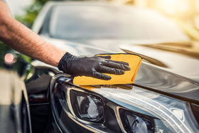 Simple Houseware towel in use on car hood removing water streaks efficiently