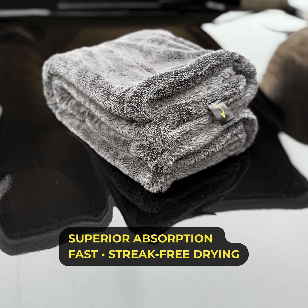 Sleek Dudes towel being wrung showing high water retention and easy handling