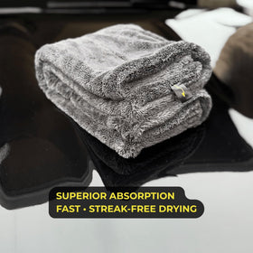 Sleek Dudes towel being wrung showing high water retention and easy handling