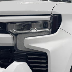 SlickMod overlay beside a ruler showing precise pre-cut fit for accurate headlight coverage.