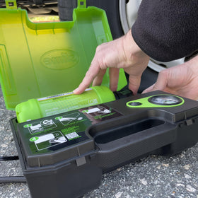 Slime 10201 cartridge next to car tire for scale, shows compact refill size