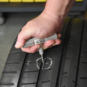 Slime kit being used on an off-road tubeless tire showing fast roadside repair benefit