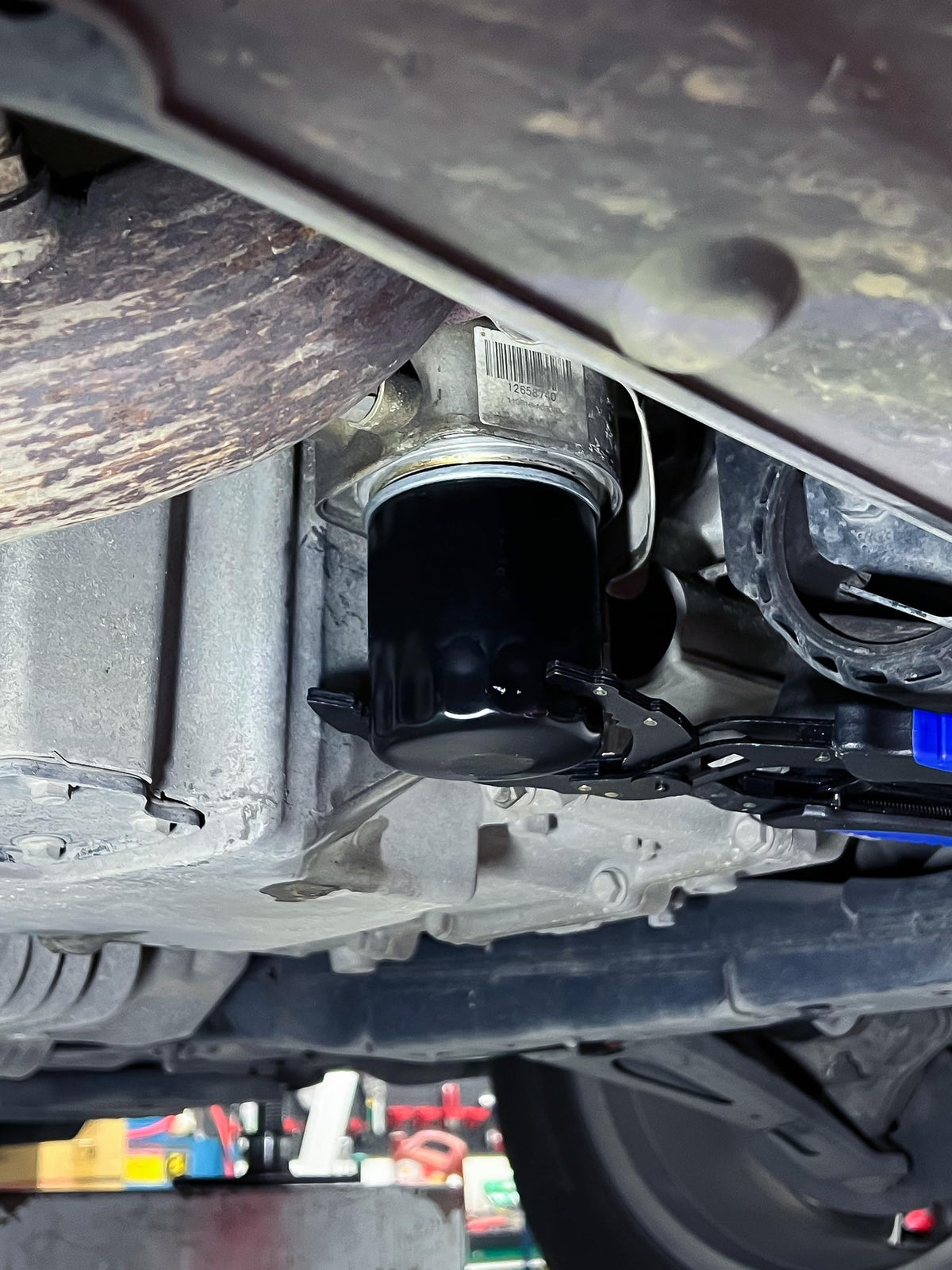 SMART JERRY wrench in garage setting helping quick DIY oil changes