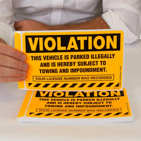SmartSign close-up of sticker edge highlighting permanent adhesive strength