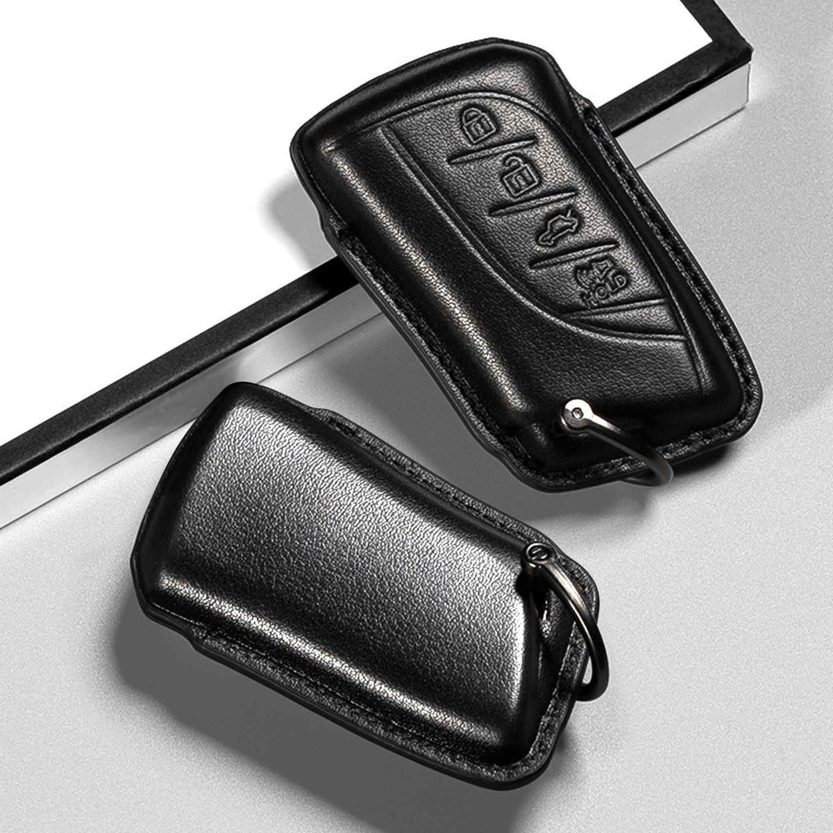 Smyfob key with matching leather lanyard held in hand for comfortable grip