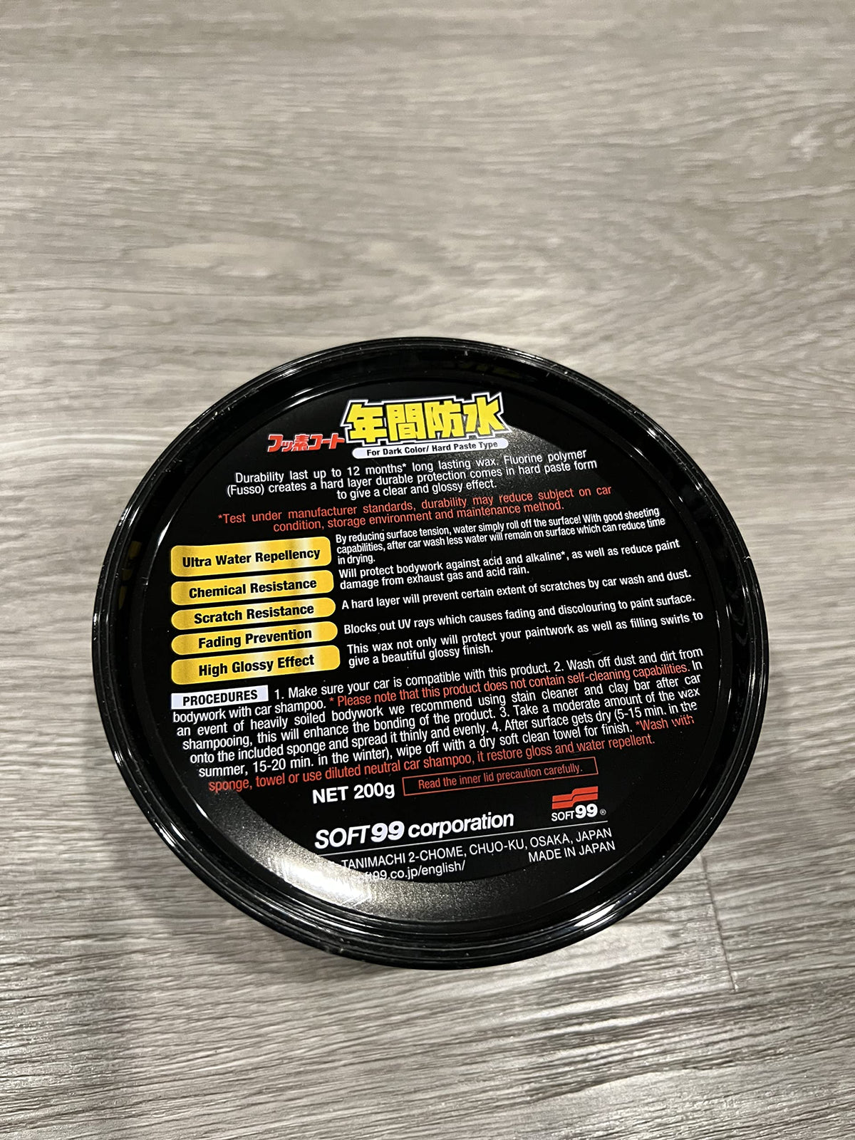 SOFT99 tin held in hands to show size and travel-friendly convenience
