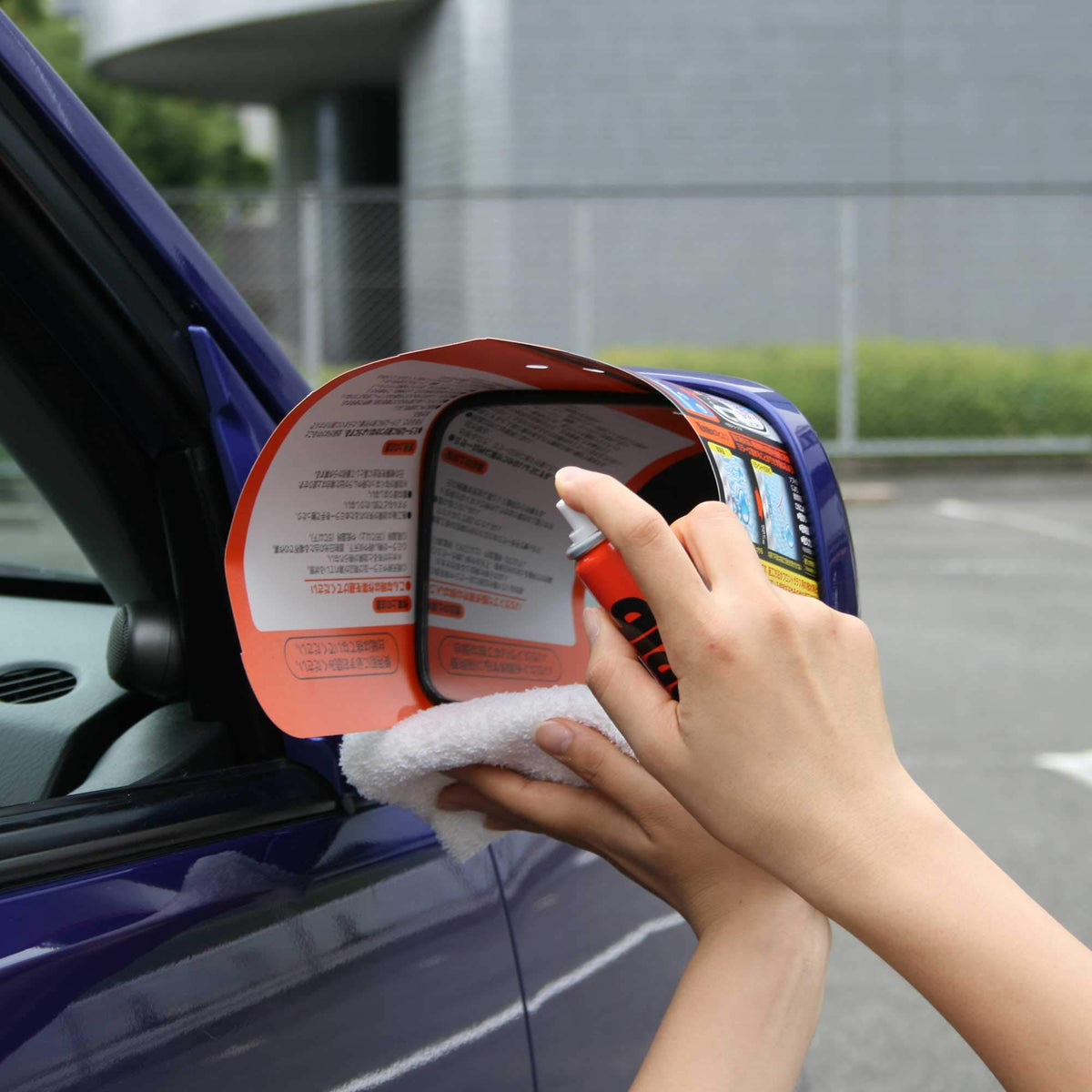SOFT99 side mirror treated with Glaco showing clear water beading and visibility benefit