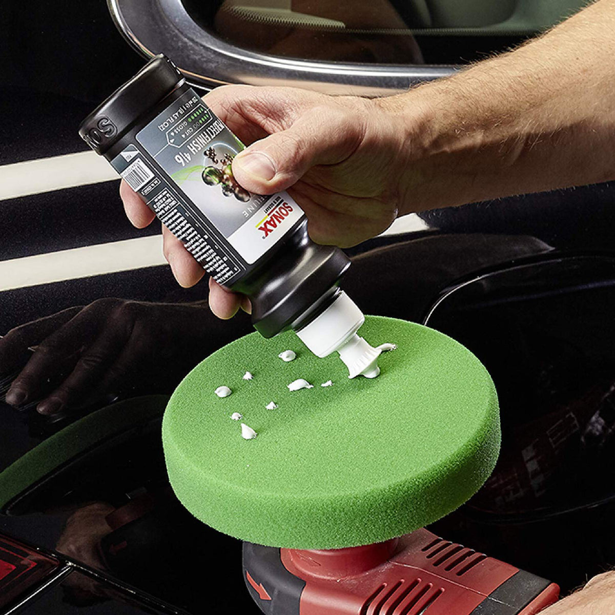 SONAX being applied to paint with pad highlighting defect removal and improved gloss