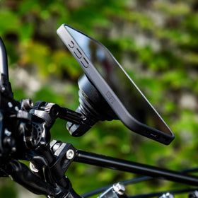 SP CONNECT SPC+ held in hand to show scale and compact design for easy bike integration