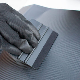 Spanno magnet attached to car panel holding film steady during alignment