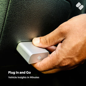 SPARQ plugged into vehicle OBD port with iPhone nearby for quick diagnostics