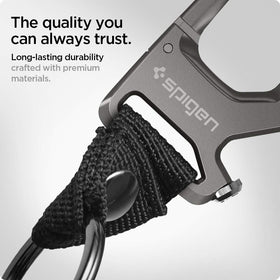 Spigen carabiner next to a coin to show compact size and pocket-friendly fit