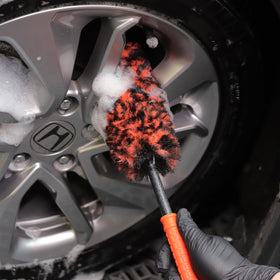 SPTA brushes used on vehicle wheel showing professional-detailing result