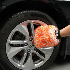 SPTA mitt next to a hand for size comparison and wide coverage