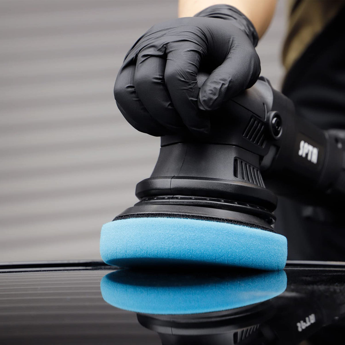 SPTA pad held in hand to show scale and comfortable handling benefit