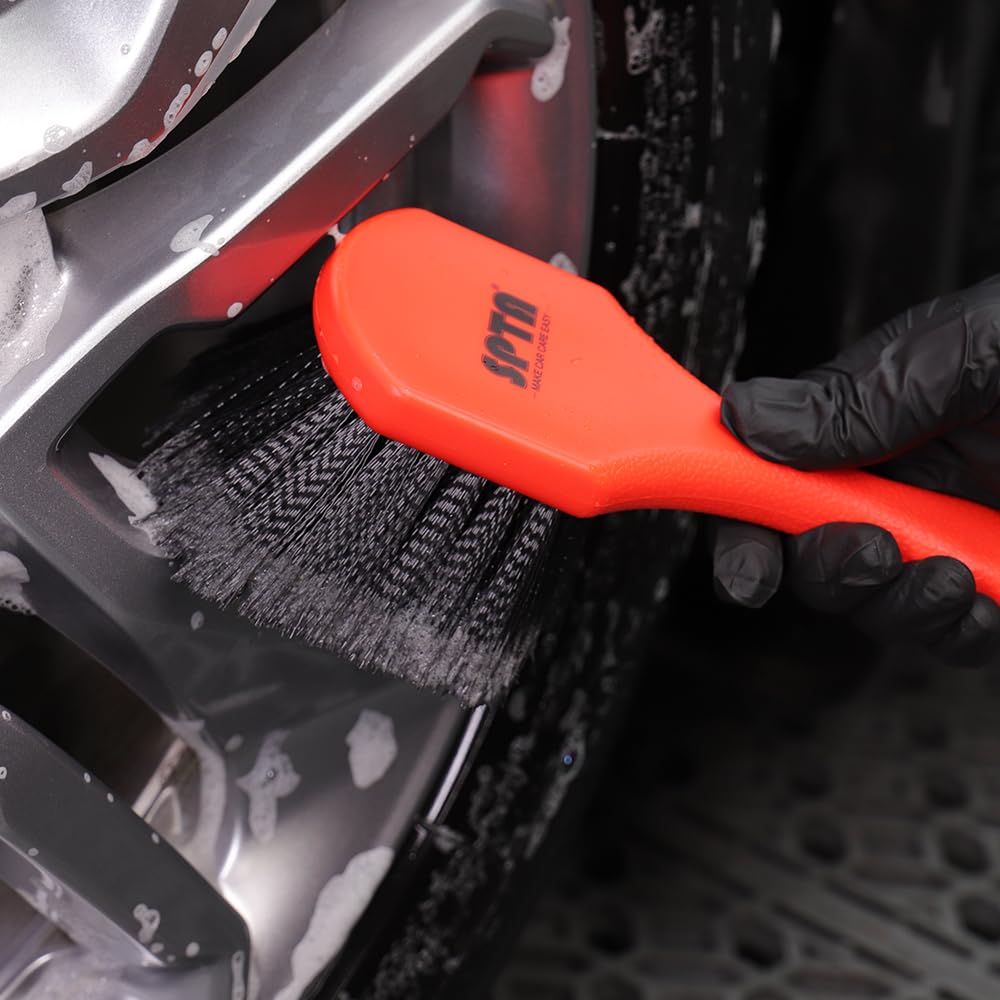 SPTA wheel being cleaned showing brush accessing spokes and removing brake dust