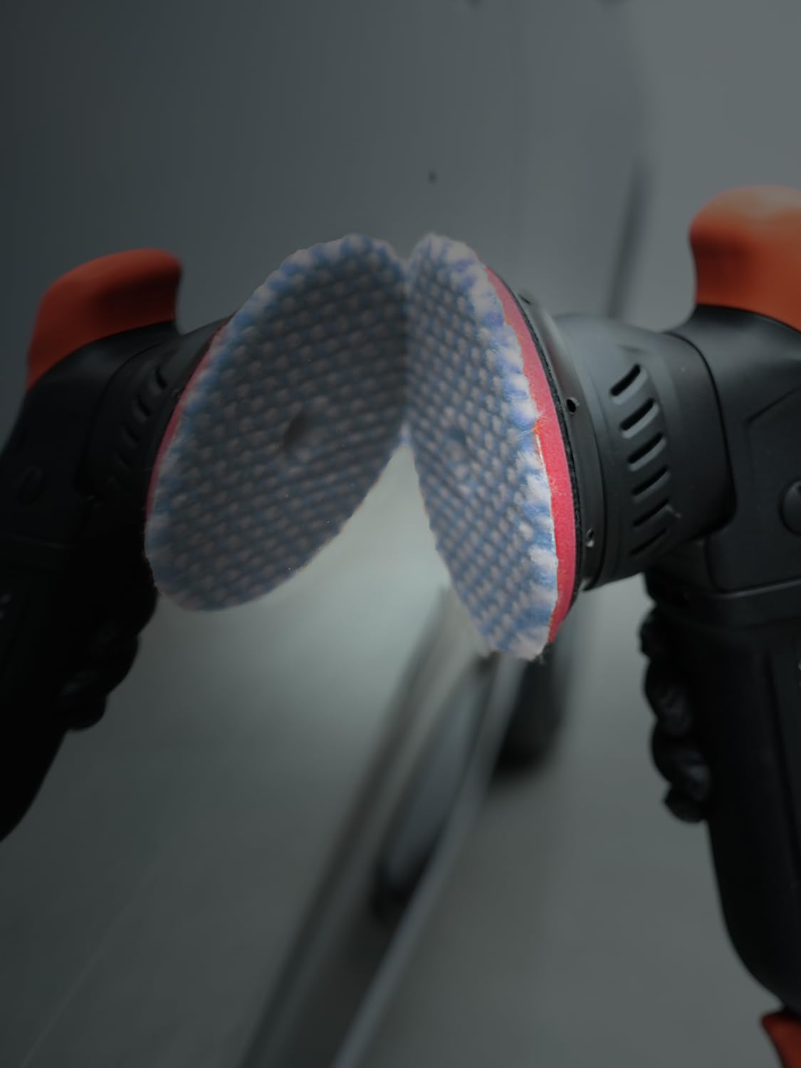 SPTA wool pad staged with polisher and compounds in a detailing kit