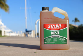 STA-BIL being poured into a truck fuel tank showing preventive application advantage.