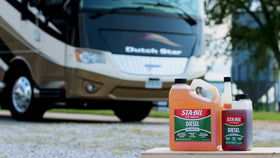 STA-BIL packaging staged with trucks and tractors highlighting fleet compatibility.