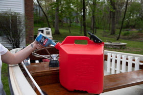 STA-BIL bottle inside engine bay illustrating treatment circulation benefit