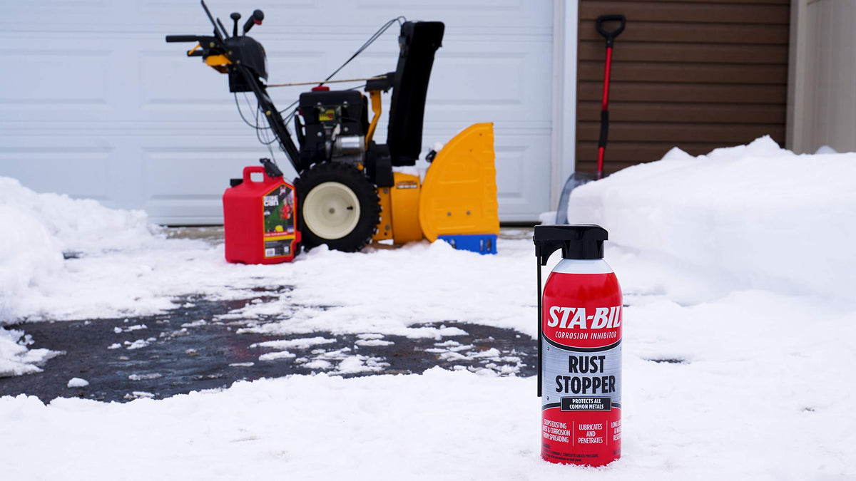 STA-BIL Rust Stopper applied to tractor hinge demonstrating protective coating and rust prevention