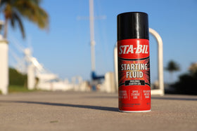 STA-BIL cans stored on garage shelf showing easy-access benefit