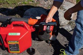 STA-BIL used with a chainsaw outdoors for reduced smoke and clean runs