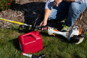 STA-BIL being added to a chainsaw fuel tank for easy maintenance