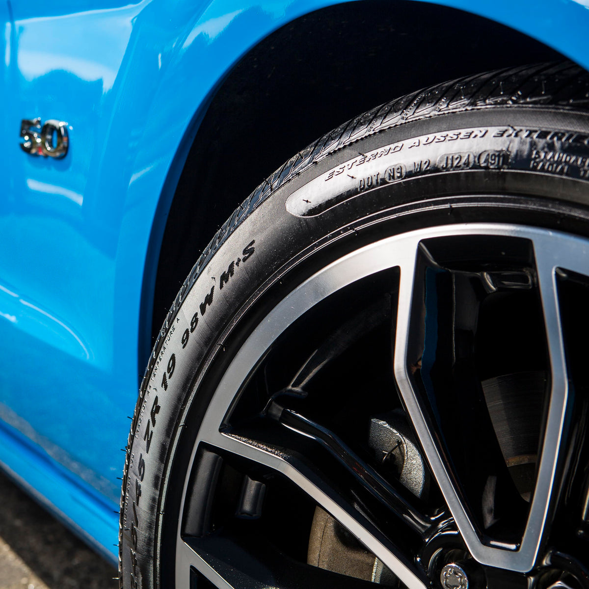 Stoner Car Care on parked car tires showing rain-resistant appearance benefit