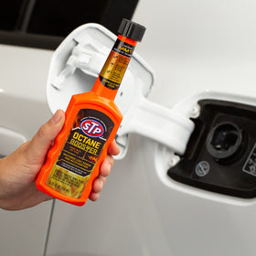 STP Octane Booster closeup of label highlighting MMT and synthetic technology benefits