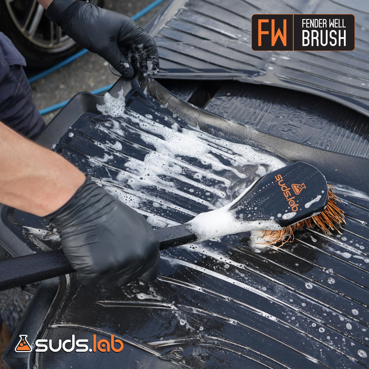 suds.lab brush cleaning a bumper and fender flare protecting finish