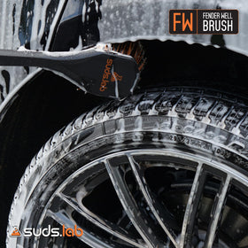 suds.lab brush beside tape measure showing 18-inch length for scale