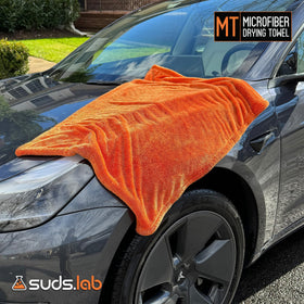 suds.lab towel wiping glass for streak-free visibility benefit