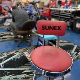 Sunex Tools stool next to toolbox showing compact footprint and scale