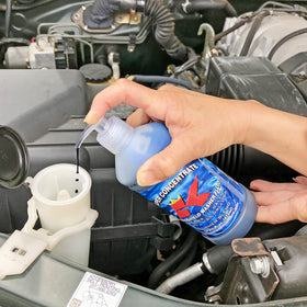 Super K Products being poured into a vehicle reservoir for clean visibility