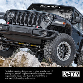 Superlift on off-road truck in action showing improved steering stability on rough terrain